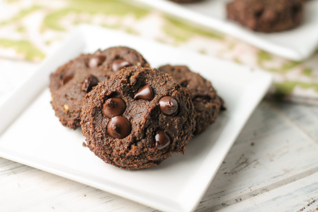 a white plate with three almond flour chocolate cookies.