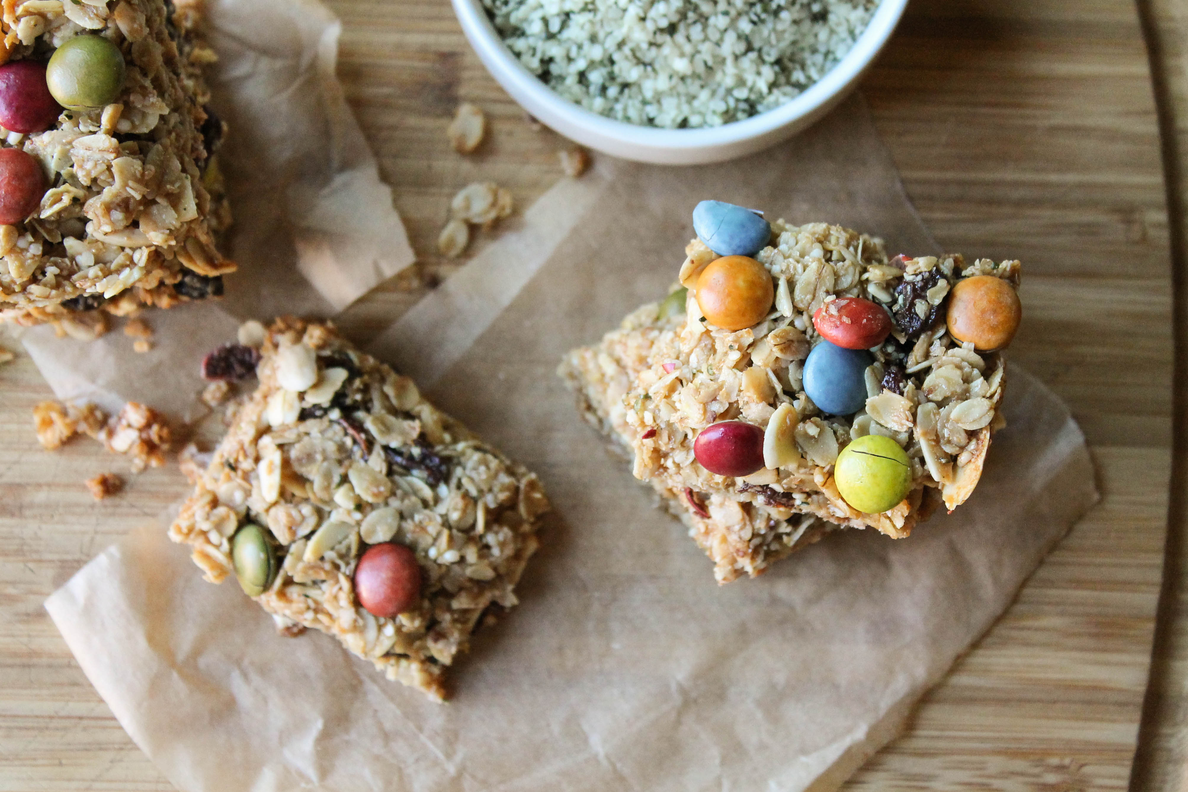 homemade granola bars with dye free m & m's from overhead on parchment