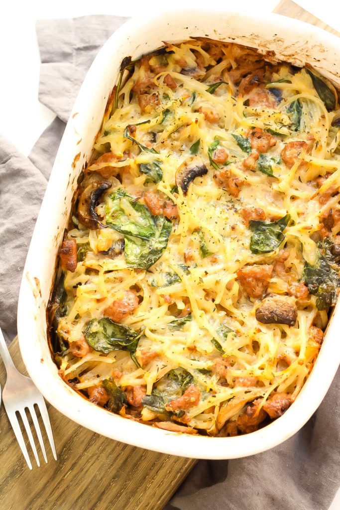 overhead shot of a n egg potato bake in a ceramic casserole dish on a wooden surface