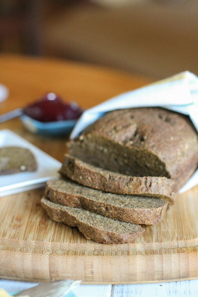 sliced loaf of keto bread on a wooden board.