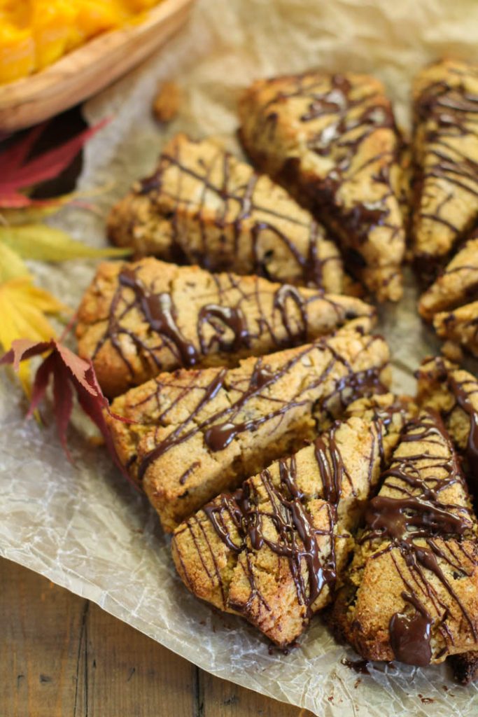 chocolate drizzled pumpkin sconescut into triangles atop a piece of parchment from overhead