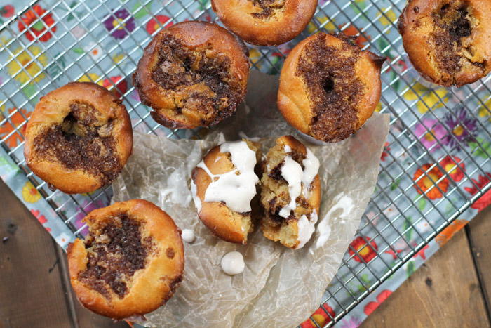 overhead shot of cinnamon streusel muffins on top of a cooling rack and sky blue floral linen