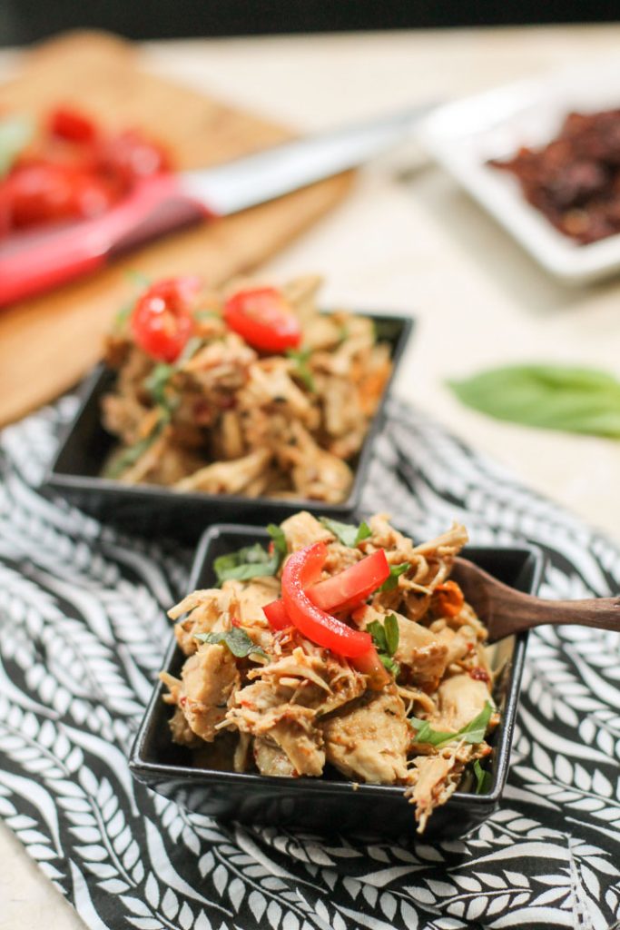 two dishes filled with creamy pulled Italian chicken with tomato and basil