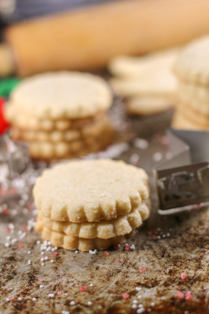 scalloped edged cut out cookies on a distressed cookie sheet