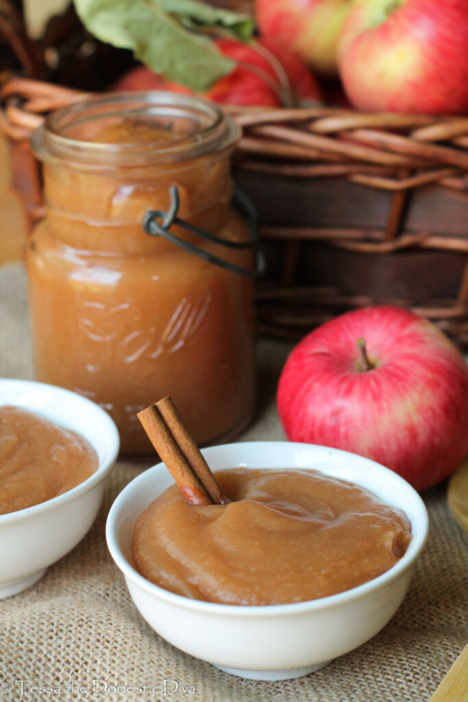 crockpot applesauce with peels in white bowls