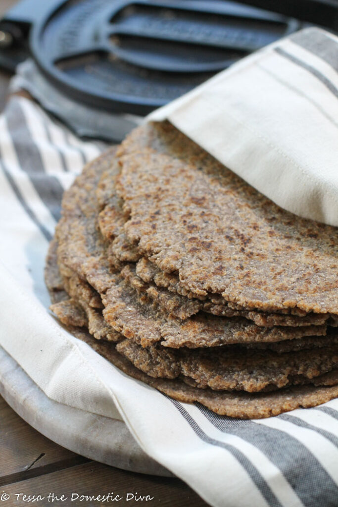 a off white and blue cloth wrapped around a stack of wholegrain tortillas