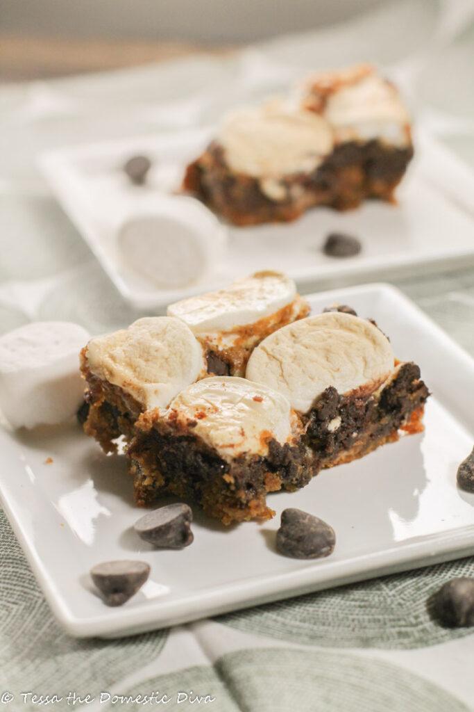 marshmallow topped chocolate chip blondies on a square white plate