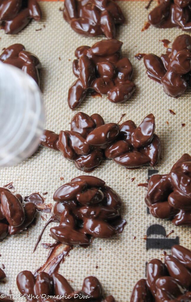 birds eye view of still molten chocolate nut clusters with flakes of salt