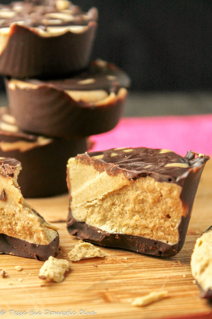 a halved homemade peanut butter cup on a wooden cutting board