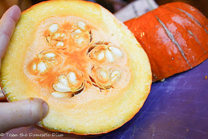 a halved fresh pumpkin with seeds