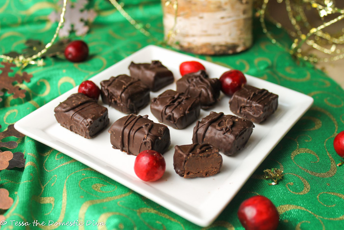 a square white plate filled with rectangle shaped homemade truffles