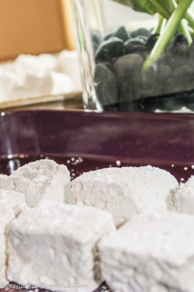 several tapioca dusted homemade marshmallows in a plum colored tray