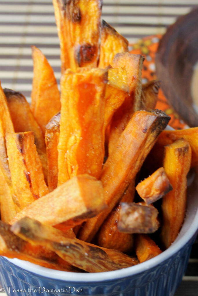  crispy sweet potato fries from above in a dark blue ramekin